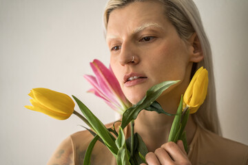 Caucasian girl holding tulip flowers and looking away