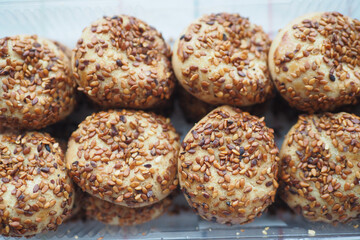 close up of sweet cookies with sesame on wooden table 