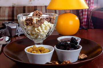 Homemade Breakfast. Cottage Cheese with Cinnamon, Jam, Nuts and Blueberries.