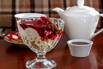 Homemade Breakfast. Cottage Cheese with Cinnamon, Jam, Nuts and Blueberries.