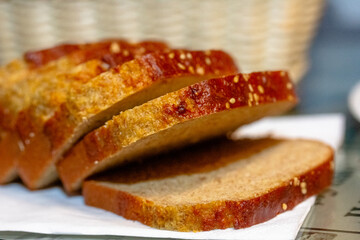 Sliced rye bread on cutting board. Whole grain rye bread with seeds on rustic background