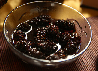 Jam from cones in a transparent bowl on the table.