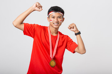 Young Indonesian man holding gold medal celebrate Indonesia independence day 17 August isolated on...