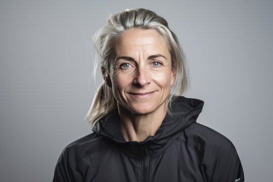 Group portrait photography of a pleased woman in her 40s wearing a comfortable tracksuit against a white background. Generative AI