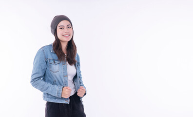 Confident asian mixed race women wear denim jacket knit cap looking at copy space on isolated white background. Funky positive cool mixed race girl upper body protect hat winter thinking something.