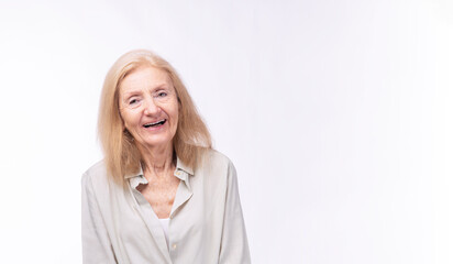 Positive friendly healthy grandmother smile looking camera over isolated white background. Caucasian elderly 70s woman blonde hair cheerful laughing relax expression joyful with copy space. Lifestyle