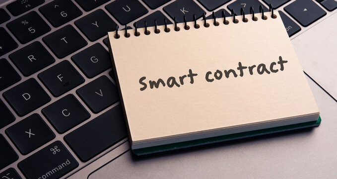 There is notebook with the word Smart contract.It is as an eye-catching image.