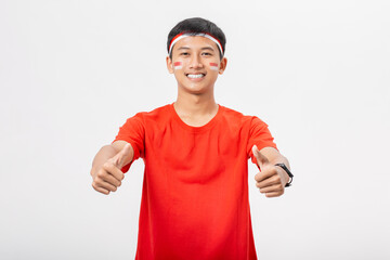 Young Indonesian man smiling doing thumbs up celebrate Indonesia independence day 17 August...