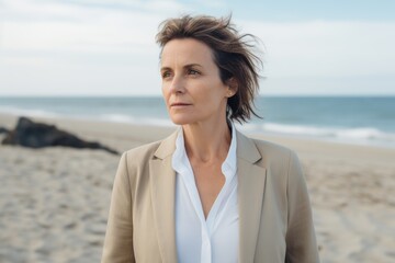 Portrait of a mature businesswoman standing on the beach at daytime