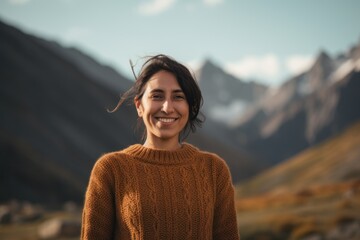 Medium shot portrait photography of a pleased woman in her 30s wearing a cozy sweater against a mountain landscape background. Generative AI