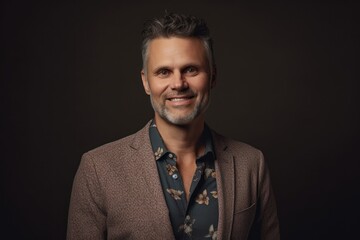 Obraz premium Portrait of a handsome man in a coat on a dark background