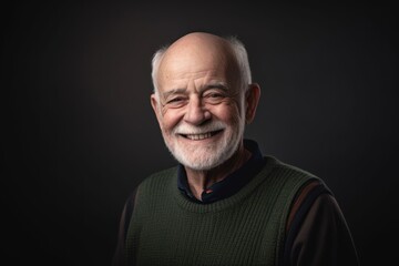 Portrait of a smiling senior man on a black background. Studio shot.
