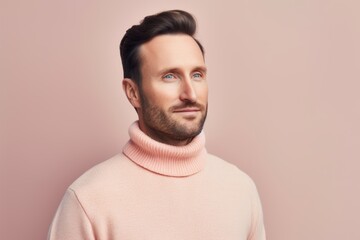 Obraz premium Portrait of handsome young man in pink sweater, isolated on pink background