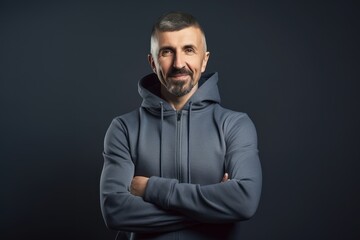 Obraz premium Handsome mature man in sportswear on dark background.