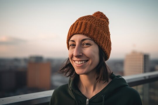 young beautiful hipster woman in the city on the roof of a skyscraper