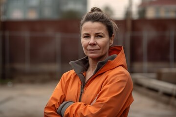 Fototapeta premium Portrait of a middle-aged woman in an orange jacket.
