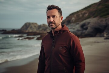 Fototapeta na wymiar Lifestyle portrait photography of a pleased man in his 40s wearing a comfortable tracksuit against an island or beach paradise background. Generative AI