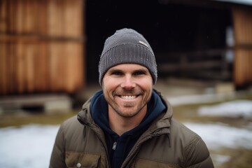 Portrait of smiling man in winter clothes looking at camera in the countryside