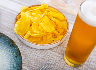 Tasty chips, sliced potato, served as snack food with beer.