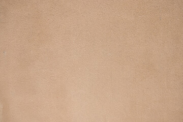 detail of the texture of a wall covered with ochre-colored concrete