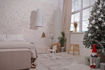 Bedroom interior with Christmas tree and festive decor