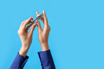 Woman with anal plug on blue background