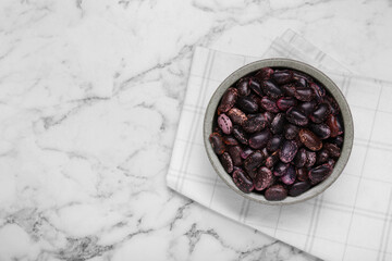 Bowl with dry kidney beans on white marble table, top view. Space for text