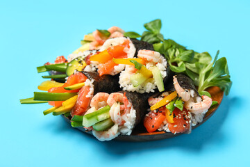Plate with delicious sushi cones and lambs lettuce on color background