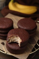 Delicious banana choco pies on table, closeup