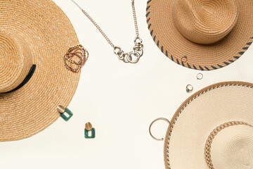 Frame made of summer hats with jewelry on light background