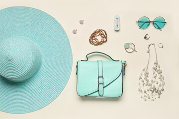 Stylish accessories with bag and summer hat on light background