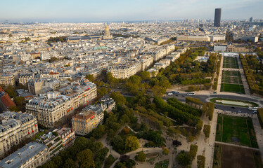 View of Paris with Champ de Mars and golden dome of Hotel des Invalides from Eiffel Tower in sunny autumn day..