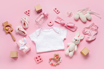 Composition with baby clothes, toys and accessories on light pink background