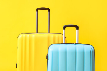 Big suitcases on yellow background, closeup