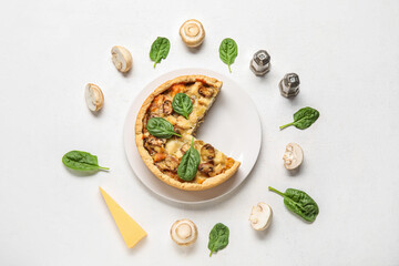 Mushroom pie with spinach leaves and champignons on white background