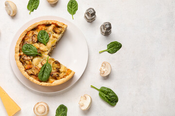 Mushroom pie with spinach leaves and champignons on white background