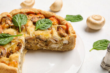 Mushroom pie with spinach leaves and champignons on white background