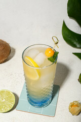 Fresh summer cocktail with lemon, winter cherry and mint on white grunge background
