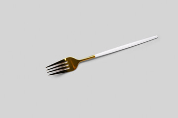 Stainless steel fork with plastic handle on grey background
