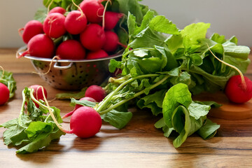 Fresh radish with green leaves on table