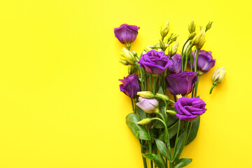 Bouquet of beautiful eustoma flowers on yellow background, closeup