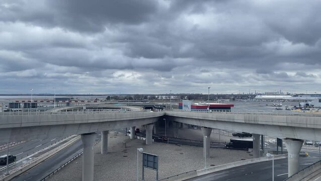 SLOW MOTION SHOT OF jfk airport advancing to the passenger terminal building on a cloudy day