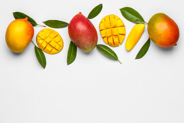 Fresh ripe mangoes on light background