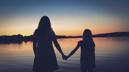 Mother and daughter enjoying the wonderful view in a beautiful sunset on Mother's Day - obrazy, fototapety, plakaty