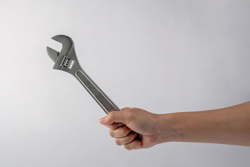 a wrench in hand isolated on white background.