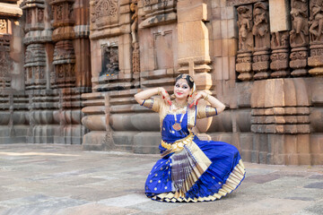 Dancer posing at temple. wearing indian classical dance costume 