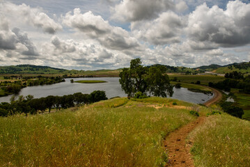 he Lagoon Valley Park in Vacaville, California, USA, viewed from a hill, including the highway I-80 on a partly cloudy day