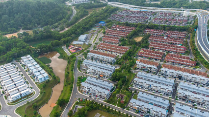 Aerial view of residential area with green asphalt road and residential houses directly above viewpoint. View of suburbs and city district. Real estate and housing market concept. - 601572612