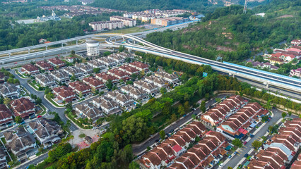 Aerial view of residential area with green asphalt road and residential houses directly above viewpoint. View of suburbs and city district. Real estate and housing market concept. - 601572626