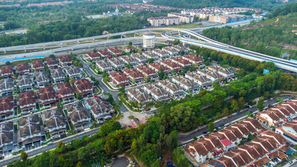 Aerial view of residential area with green asphalt road and residential houses directly above viewpoint. View of suburbs and city district. Real estate and housing market concept. - 601572629